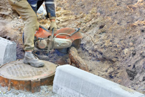 Specialist removing a tree root from a sewage line